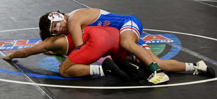Dallas Russell of Jefferson topples Jose Gutierrez of Doral Academy during a 150-pound semifinals match on Saturday at the Knockout Christmas Classic at Silver Spurs Arena in Kissimmee.